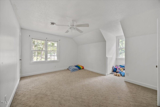 1013 Oak Forest Dr NW, Wilson, NC 27896 - bonus room featuring lofted ceiling, carpet floors, ceiling fan, and a textured ceiling