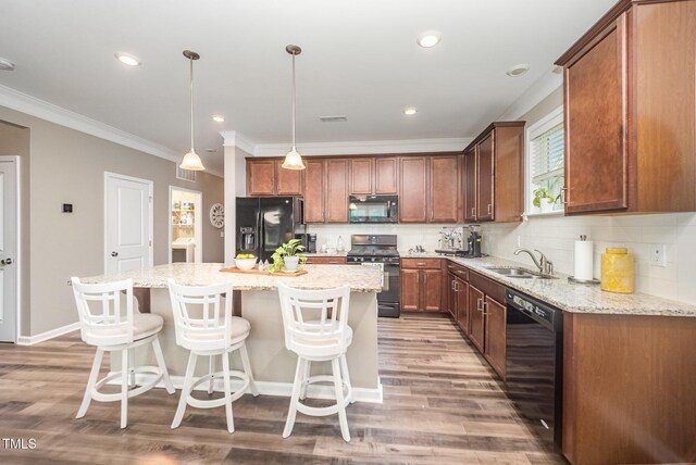 3037 Willow Ranch Dr, Fuquay Varina, NC 27526 - kitchen featuring black appliances, ornamental molding, a center island, light wood-style flooring, and tasteful backsplash