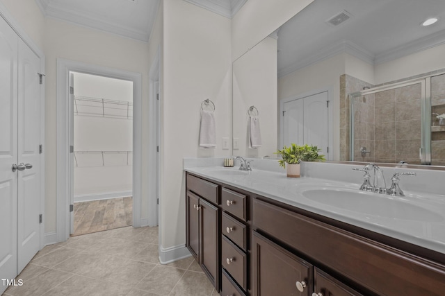 801 Socata Ln, Mebane, NC 27302 - full bath featuring ornamental molding, double vanity, a shower stall, tile patterned floors, and a spacious closet