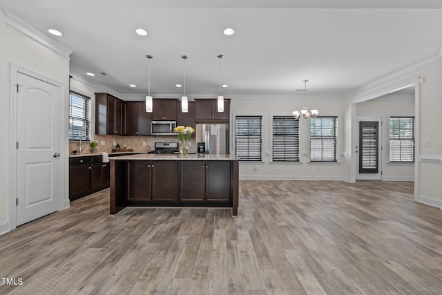 801 Socata Ln, Mebane, NC 27302 - kitchen featuring appliances with stainless steel finishes, dark brown cabinetry, a chandelier, light wood-style floors, and ornamental molding