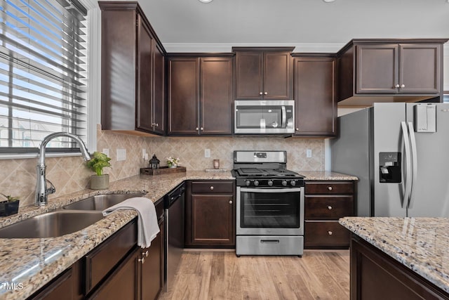 801 Socata Ln, Mebane, NC 27302 - kitchen with stainless steel appliances, dark brown cabinets, light wood-style flooring, and light stone counters