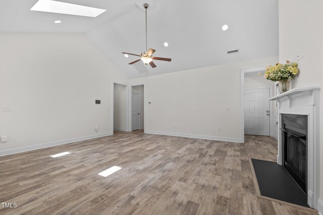 801 Socata Ln, Mebane, NC 27302 - unfurnished living room featuring a skylight, a fireplace, high vaulted ceiling, light wood-type flooring, and ceiling fan