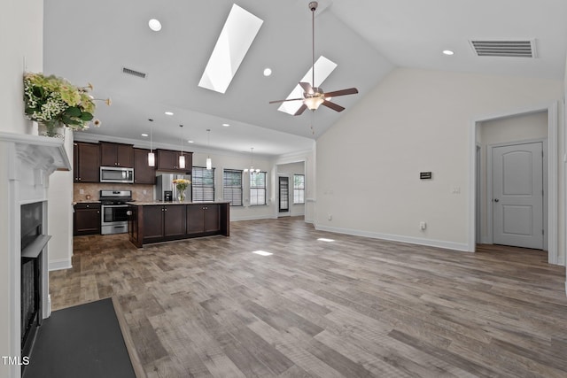 801 Socata Ln, Mebane, NC 27302 - unfurnished living room featuring a fireplace, ceiling fan, recessed lighting, light wood-type flooring, and high vaulted ceiling