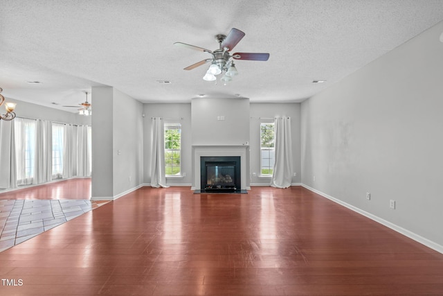 760 Stackhurst Way, Wake Forest, NC 27587 - unfurnished living room with wood finished floors, ceiling fan, a textured ceiling, and a fireplace with flush hearth