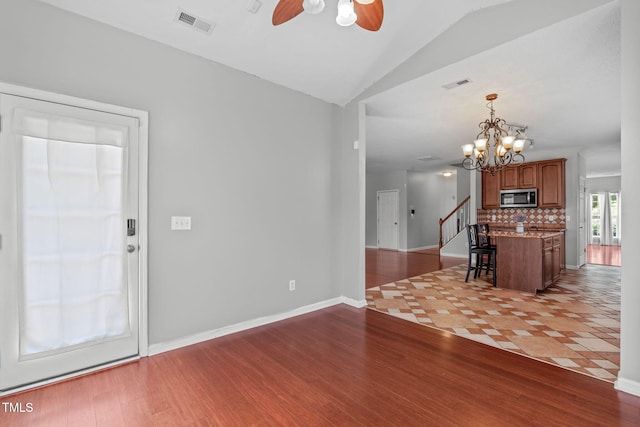 760 Stackhurst Way, Wake Forest, NC 27587 - living room with ceiling fan, wood finished floors, lofted ceiling, a chandelier, and stairway