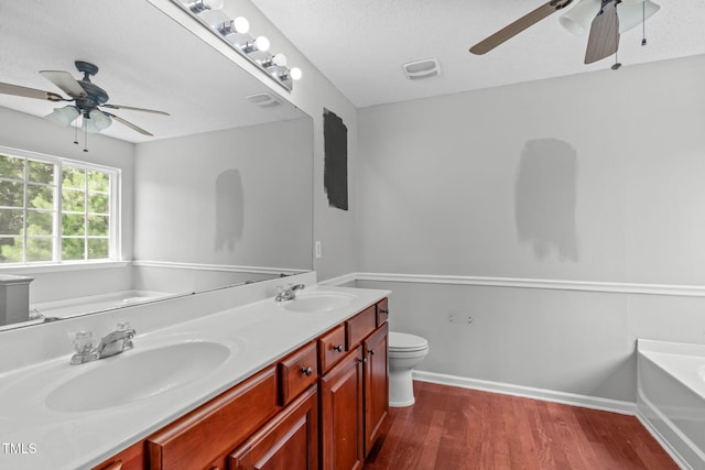 760 Stackhurst Way, Wake Forest, NC 27587 - full bathroom with ceiling fan, a garden tub, wood finished floors, double vanity, and a textured ceiling