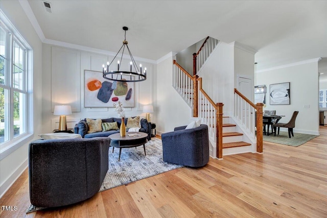 8011 Old Trail Dr, Durham, NC 27712 - living area with light wood finished floors, a chandelier, stairs, crown molding, and baseboards