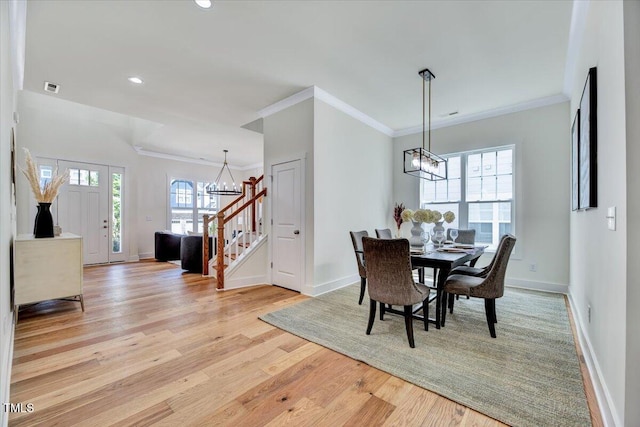 8011 Old Trail Dr, Durham, NC 27712 - dining area featuring a chandelier, stairway, light wood-style flooring, recessed lighting, and ornamental molding