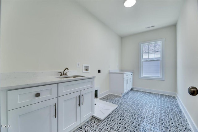 8011 Old Trail Dr, Durham, NC 27712 - laundry room with baseboards, cabinet space, hookup for a washing machine, and light flooring