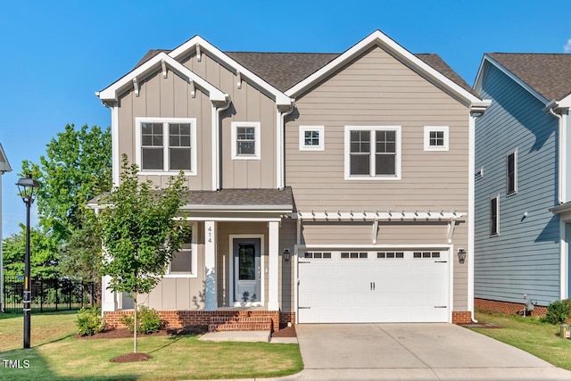 414 Wyndham Dr, Chapel Hill, NC 27516 - view of front facade featuring board and batten siding, driveway, a front lawn, and a garage
