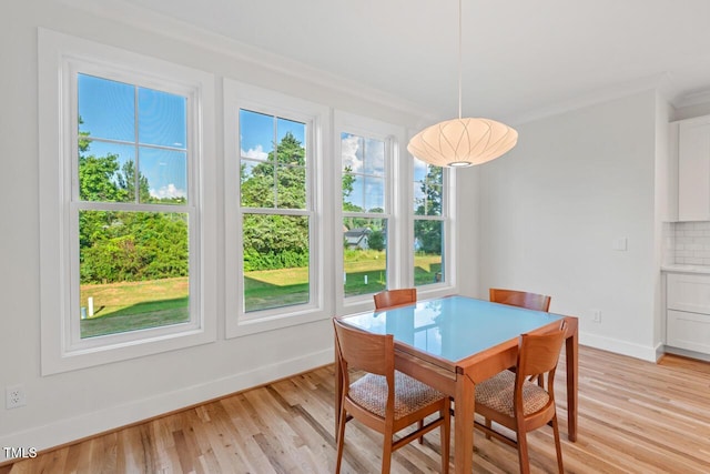 414 Wyndham Dr, Chapel Hill, NC 27516 - dining room with healthy amount of natural light, light wood finished floors, and crown molding
