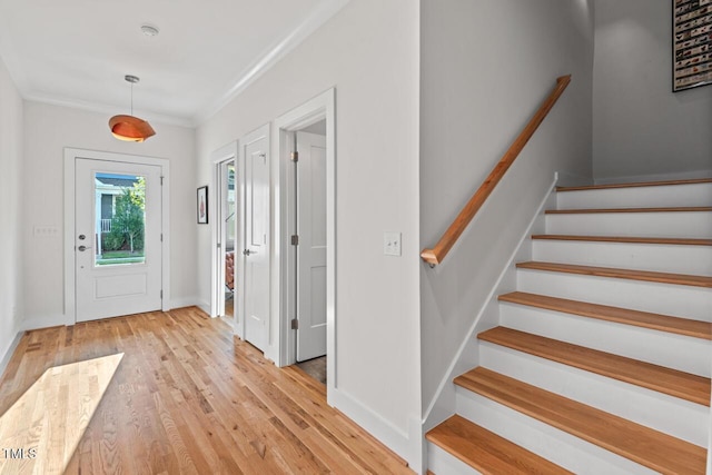 414 Wyndham Dr, Chapel Hill, NC 27516 - entryway featuring light wood-style floors, stairway, and crown molding