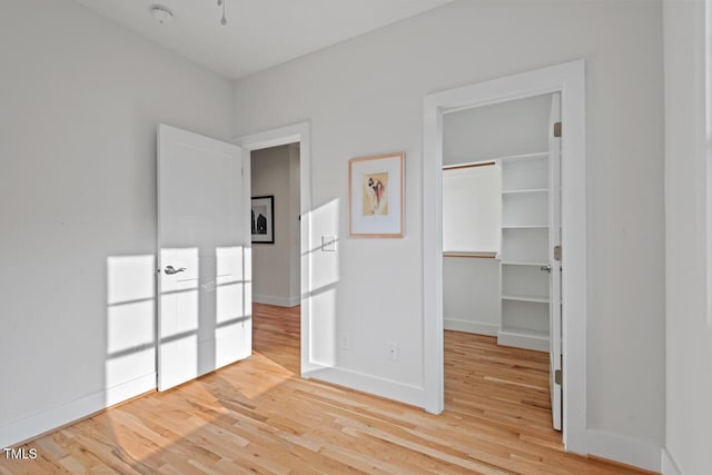 414 Wyndham Dr, Chapel Hill, NC 27516 - unfurnished bedroom with light wood-type flooring, a walk in closet, and a closet