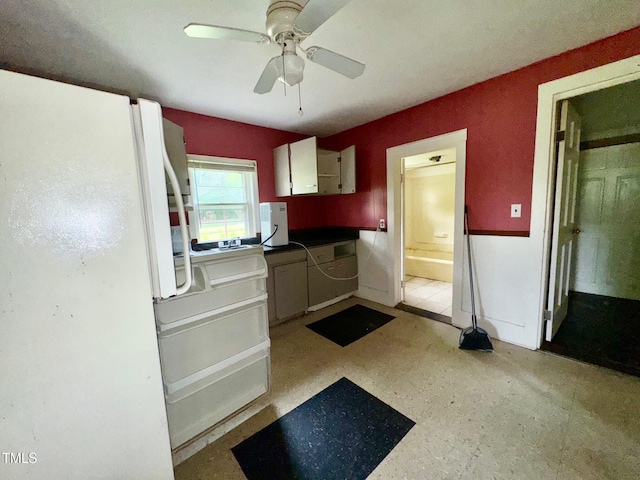 209 Rogers St, Norlina, NC 27563 - kitchen with freestanding refrigerator, ceiling fan, and white cabinets