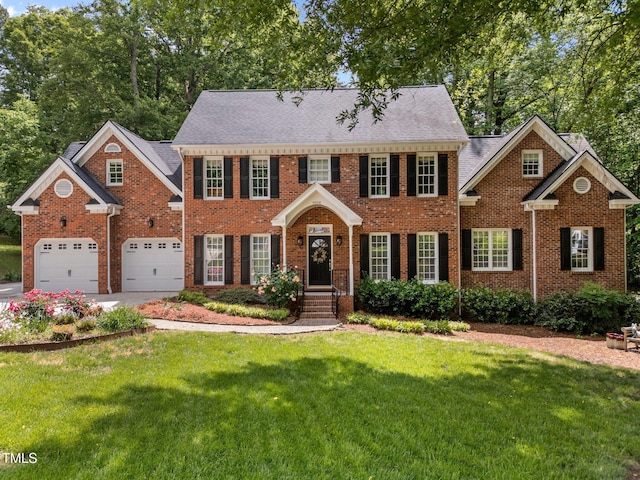 8004 Gabriels Bend Dr, Raleigh, NC 27612 - colonial inspired home with a front yard, a garage, brick siding, concrete driveway, and a shingled roof
