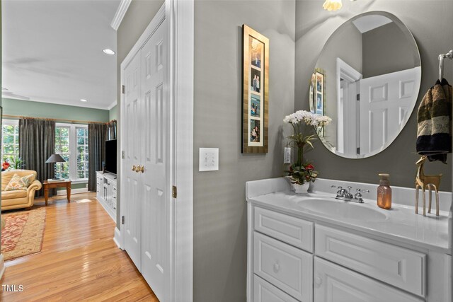 8004 Gabriels Bend Dr, Raleigh, NC 27612 - bathroom with wood finished floors, vanity, recessed lighting, and ornamental molding