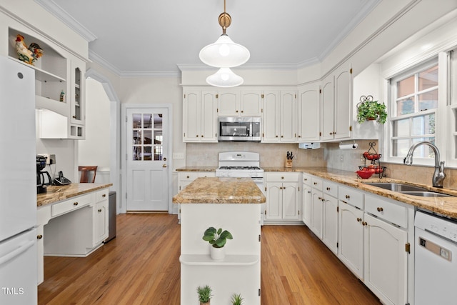 8004 Gabriels Bend Dr, Raleigh, NC 27612 - kitchen featuring white appliances, decorative backsplash, a center island, crown molding, and light wood finished floors
