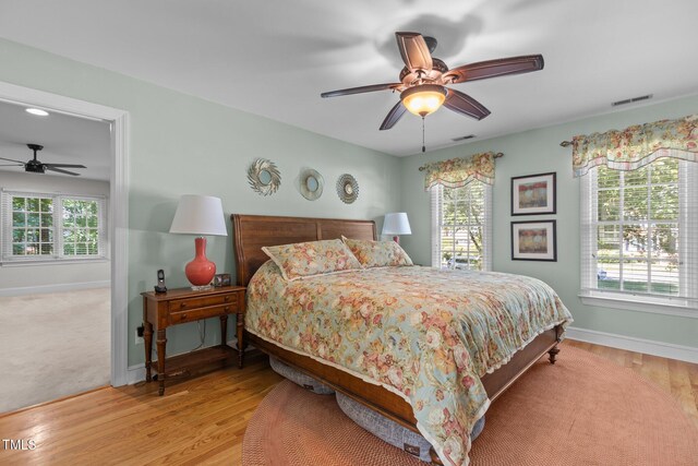 8004 Gabriels Bend Dr, Raleigh, NC 27612 - bedroom featuring light wood-style floors and a ceiling fan