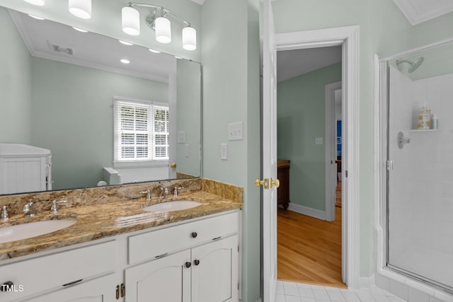 8004 Gabriels Bend Dr, Raleigh, NC 27612 - full bathroom featuring ornamental molding, a shower stall, double vanity, and tile patterned floors