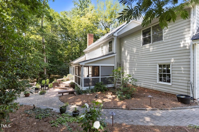 8004 Gabriels Bend Dr, Raleigh, NC 27612 - view of side of property with a patio and a chimney