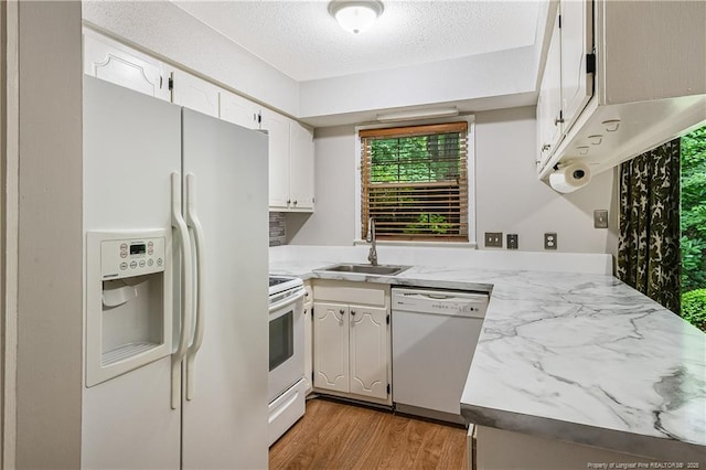 1255 Donaldson Ct, Cary, NC 27511 - kitchen featuring white appliances, a sink, light countertops, white cabinetry, and a textured ceiling