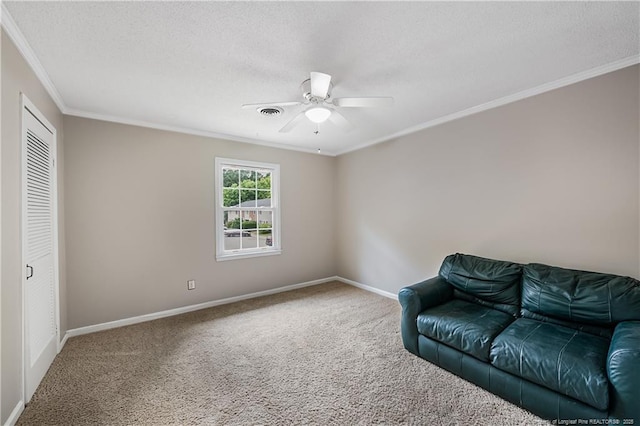 1255 Donaldson Ct, Cary, NC 27511 - sitting room featuring carpet floors, ornamental molding, baseboards, ceiling fan, and a textured ceiling