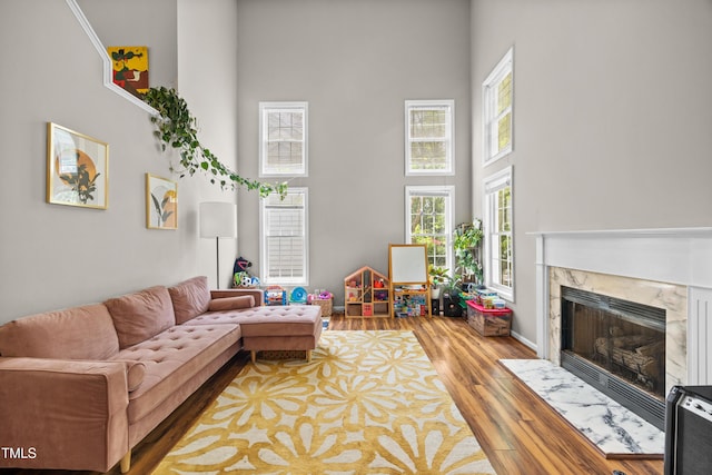 304 Gold Point Dr, Cary, NC 27519 - living room with a high ceiling, a high end fireplace, and wood finished floors
