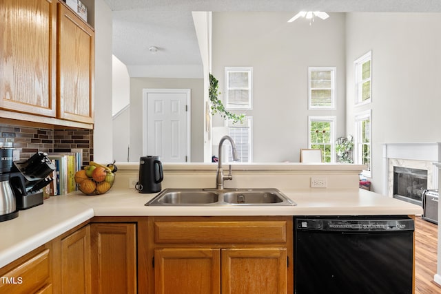 304 Gold Point Dr, Cary, NC 27519 - kitchen with dishwasher, a premium fireplace, light countertops, backsplash, and brown cabinets