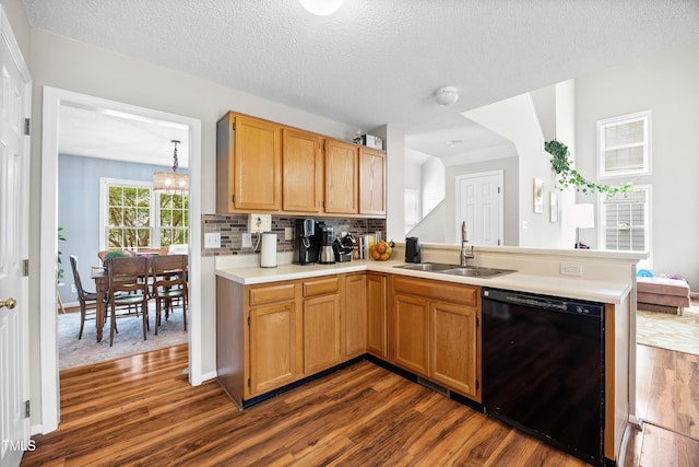 304 Gold Point Dr, Cary, NC 27519 - kitchen with dishwasher, dark wood finished floors, a peninsula, light countertops, and backsplash