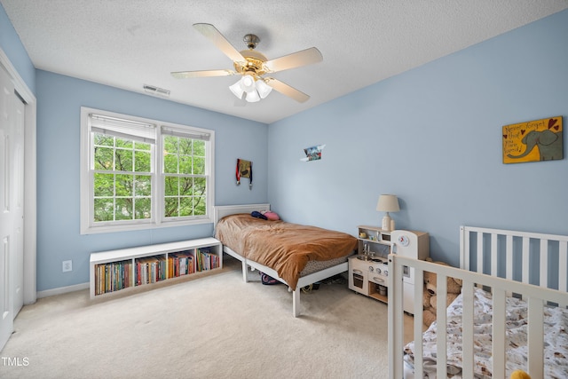 304 Gold Point Dr, Cary, NC 27519 - carpeted bedroom featuring a closet, a textured ceiling, and ceiling fan