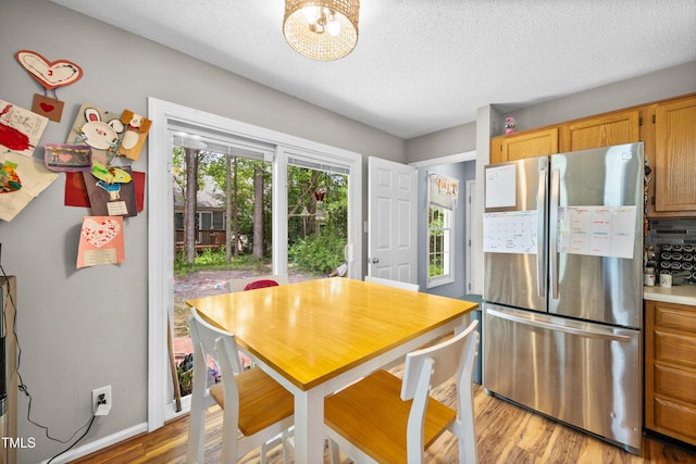 304 Gold Point Dr, Cary, NC 27519 - dining room with light wood-style floors and a textured ceiling