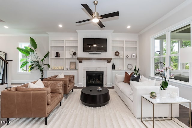 4104 Green Chase Way, Apex, NC 27539 - living room featuring crown molding, wood finished floors, a fireplace, a ceiling fan, and recessed lighting