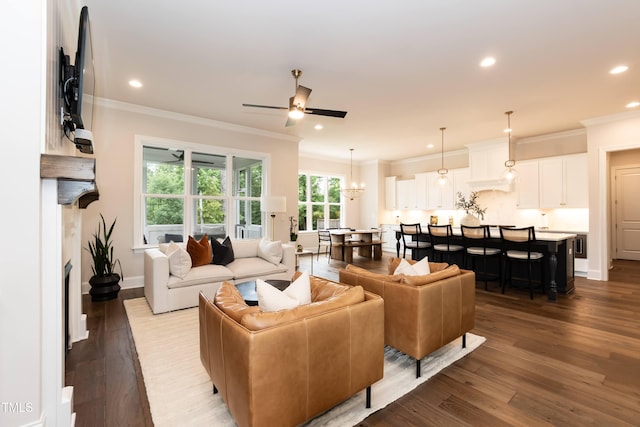 4104 Green Chase Way, Apex, NC 27539 - living room with ornamental molding, dark wood finished floors, recessed lighting, a ceiling fan, and a chandelier