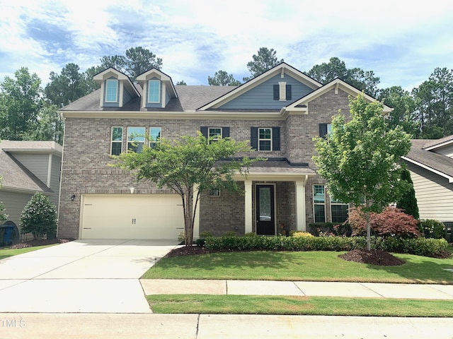 1205 Capstone Dr, Durham, NC 27713 - view of front of home with brick siding, an attached garage, a front yard, and concrete driveway