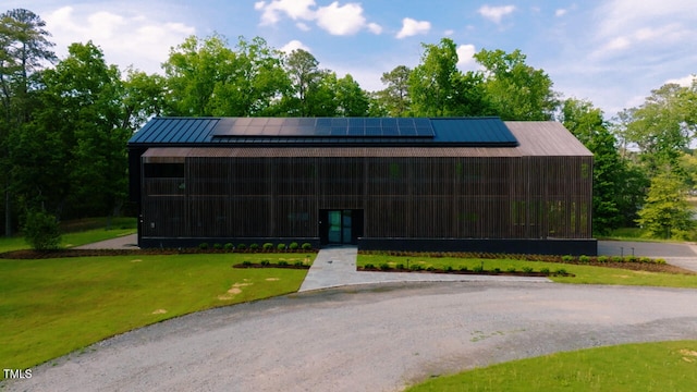 4725 Creeks Junction Rd, Blounts Creek, NC 27814 - view of front of property with a standing seam roof, roof mounted solar panels, a front yard, and a metal roof