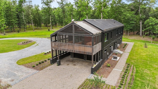 4725 Creeks Junction Rd, Blounts Creek, NC 27814 - view of front of property featuring a sunroom, driveway, a carport, a front yard, and view of scattered trees