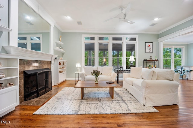 105 Gorge Ct, Cary, NC 27518 - living area with ornamental molding, a ceiling fan, a fireplace, wood finished floors, and recessed lighting