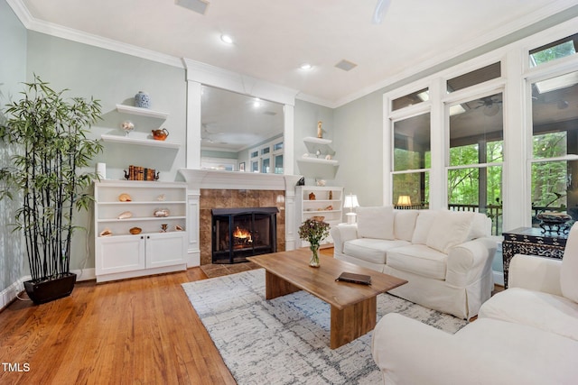 105 Gorge Ct, Cary, NC 27518 - living room with light wood-style flooring, ornamental molding, a ceiling fan, a tile fireplace, and recessed lighting