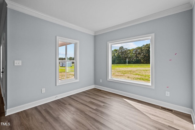 2237 Heartland Rd, Battleboro, NC 27809 - unfurnished room featuring ornamental molding, plenty of natural light, baseboards, and wood finished floors