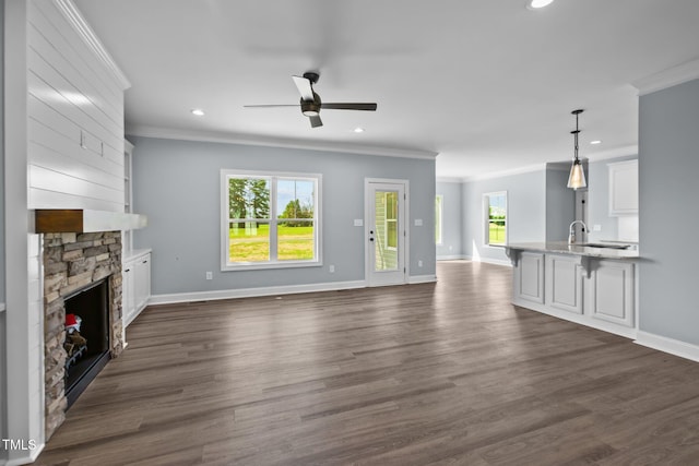 2237 Heartland Rd, Battleboro, NC 27809 - unfurnished living room with crown molding, recessed lighting, ceiling fan, baseboards, and a fireplace