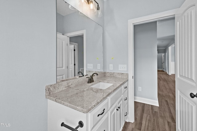 2237 Heartland Rd, Battleboro, NC 27809 - bathroom with baseboards, wood finished floors, and vanity