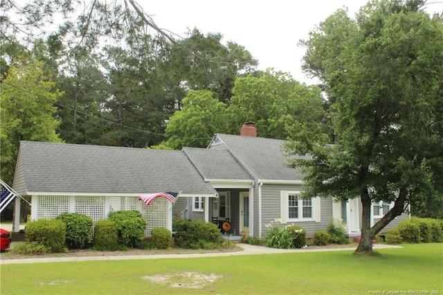4903 Lemon Springs Rd, Sanford, NC 27332 - view of front of house with a front lawn, a chimney, and a shingled roof