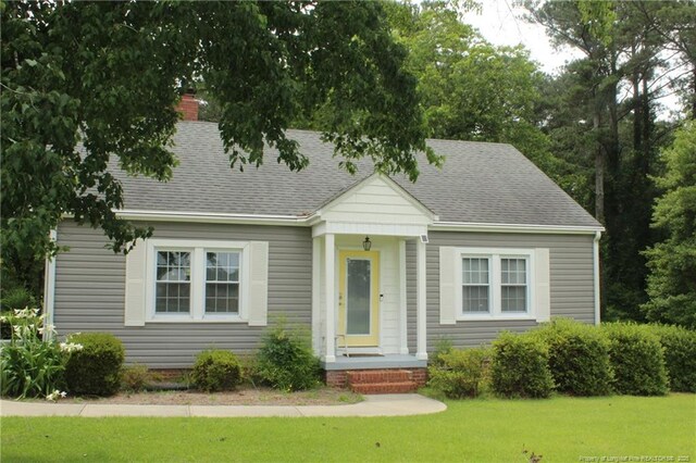 4903 Lemon Springs Rd, Sanford, NC 27332 - new england style home featuring a front lawn and a shingled roof