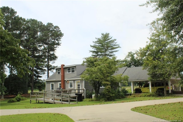 4903 Lemon Springs Rd, Sanford, NC 27332 - view of front facade with a wooden deck, a front lawn, and a chimney