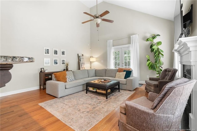 951 Whispering Pines Dr, Spring Lake, NC 28390 - living room with high vaulted ceiling, ceiling fan, wood finished floors, a fireplace, and baseboards