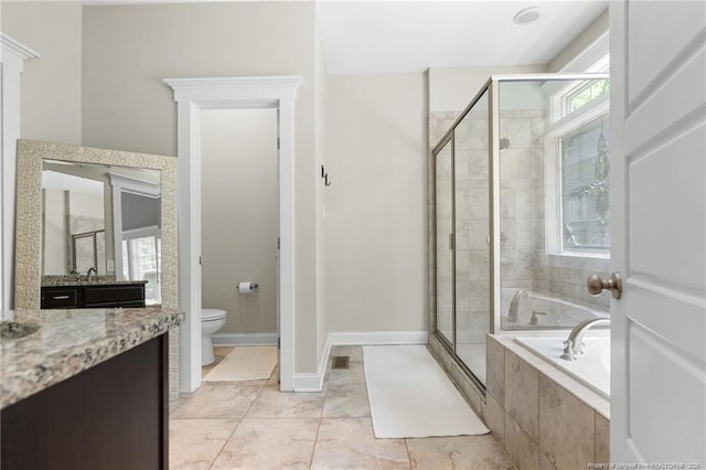 951 Whispering Pines Dr, Spring Lake, NC 28390 - full bathroom featuring a stall shower, a garden tub, vanity, toilet, and baseboards