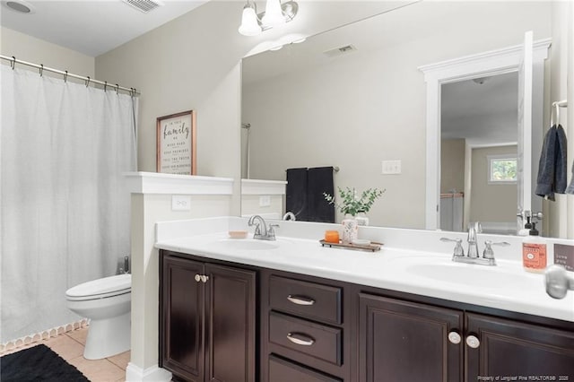 951 Whispering Pines Dr, Spring Lake, NC 28390 - full bathroom featuring toilet, tile patterned floors, double vanity, and a shower with shower curtain