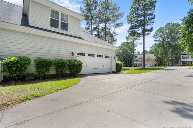 951 Whispering Pines Dr, Spring Lake, NC 28390 - view of home's exterior featuring concrete driveway, roof with shingles, and a lawn