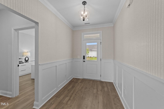 1319 Richfield Oaks Dr, Fuquay Varina, NC 27526 - doorway to outside with crown molding, dark wood finished floors, a wainscoted wall, a chandelier, and a decorative wall