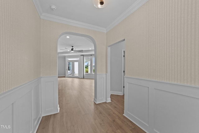 1319 Richfield Oaks Dr, Fuquay Varina, NC 27526 - hall with arched walkways, crown molding, wood finished floors, wainscoting, and a decorative wall